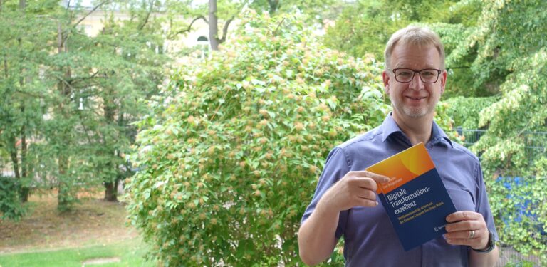 Uwe Brüggemann zeigt sein Buch über Digitalisierung